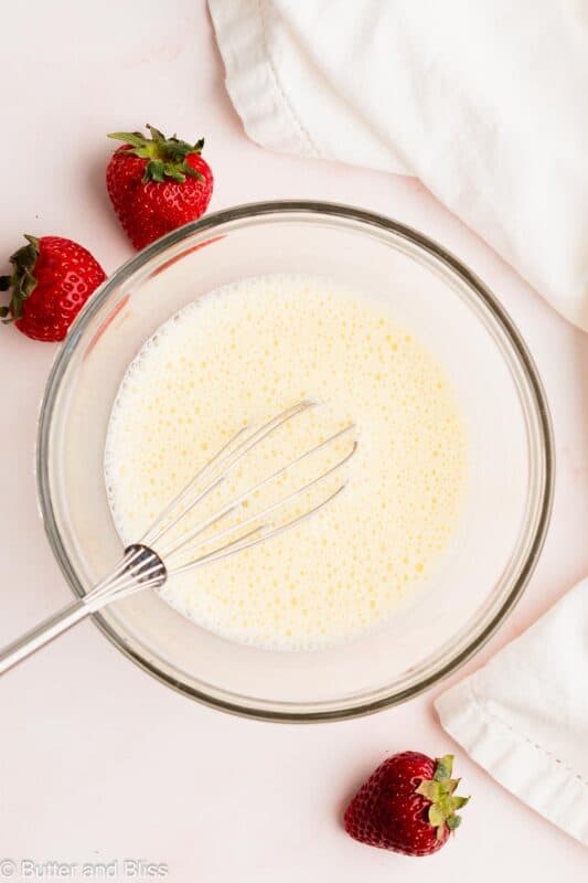 Cornstarch slurry in a mixing bowl with a whisk.