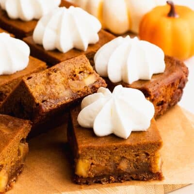 Pumpkin pie squares arranged on a wood tray.