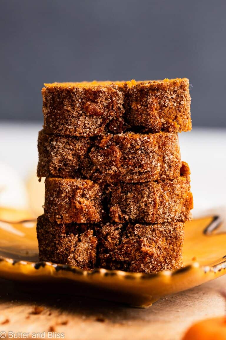 Stack of pumpkin bread slices with cinnamon sugar top.