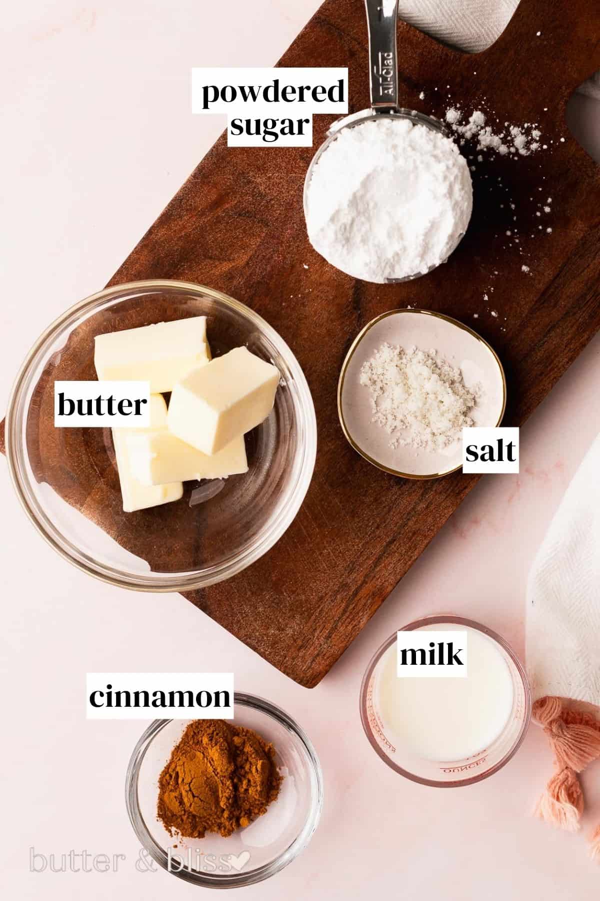 Ingredients for fall flavored pastry icing in small bowls on a table.