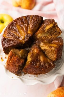 Slices of small apple cider bread on a cake platter.
