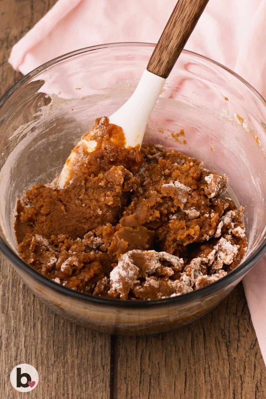 Flour being mixed into pumpkin cookie bar dough.