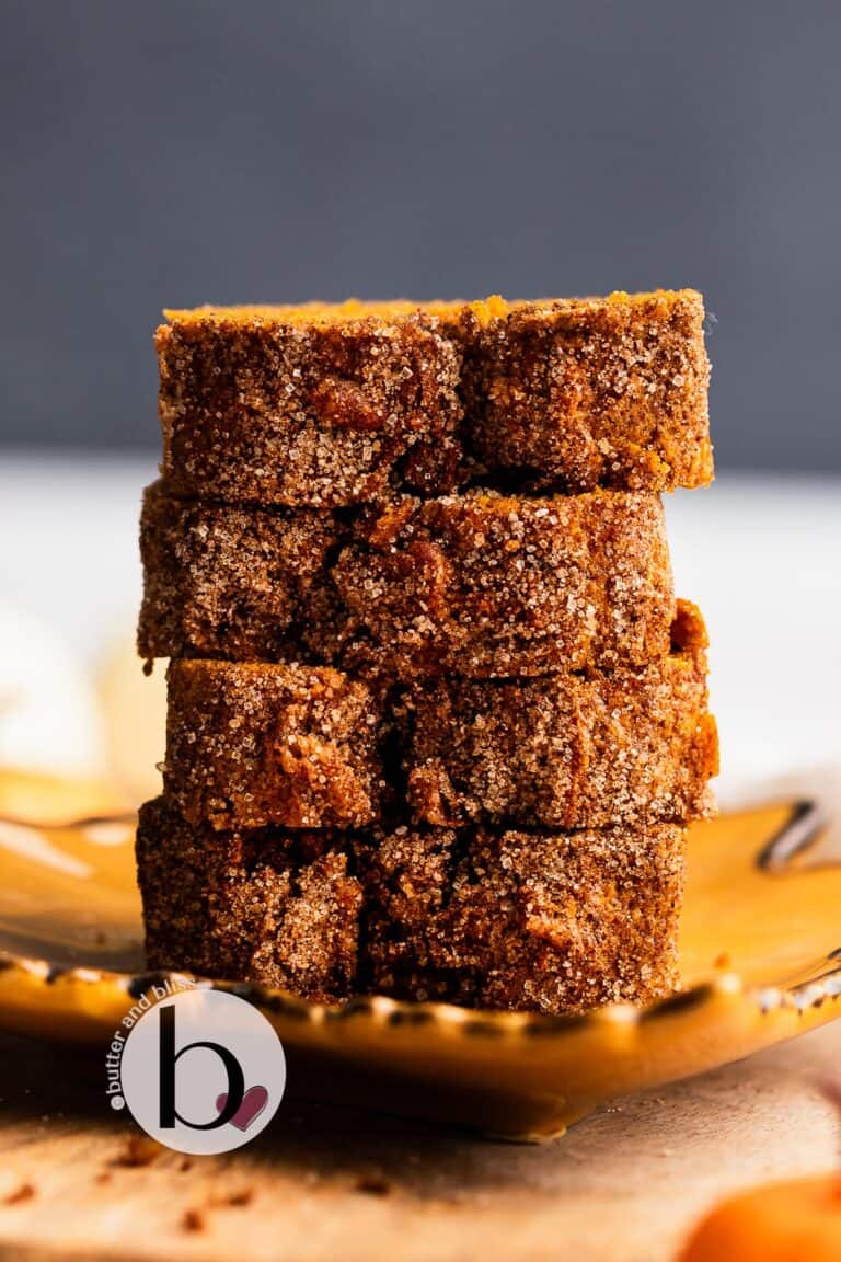 Stack of pumpkin bread slices with cinnamon sugar top.