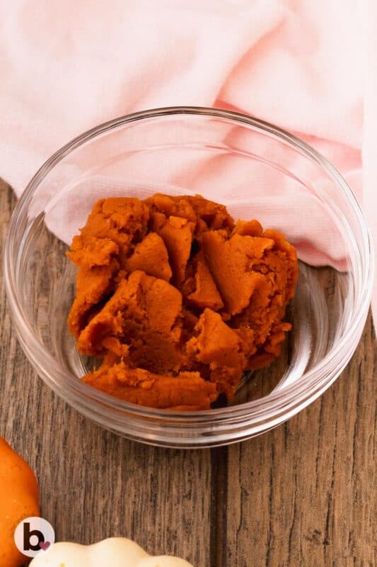 Thick pumpkin puree in a small bowl.