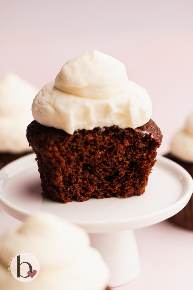 Moist inside of an eggless chocolate cupcake on a mini cupcake stand.