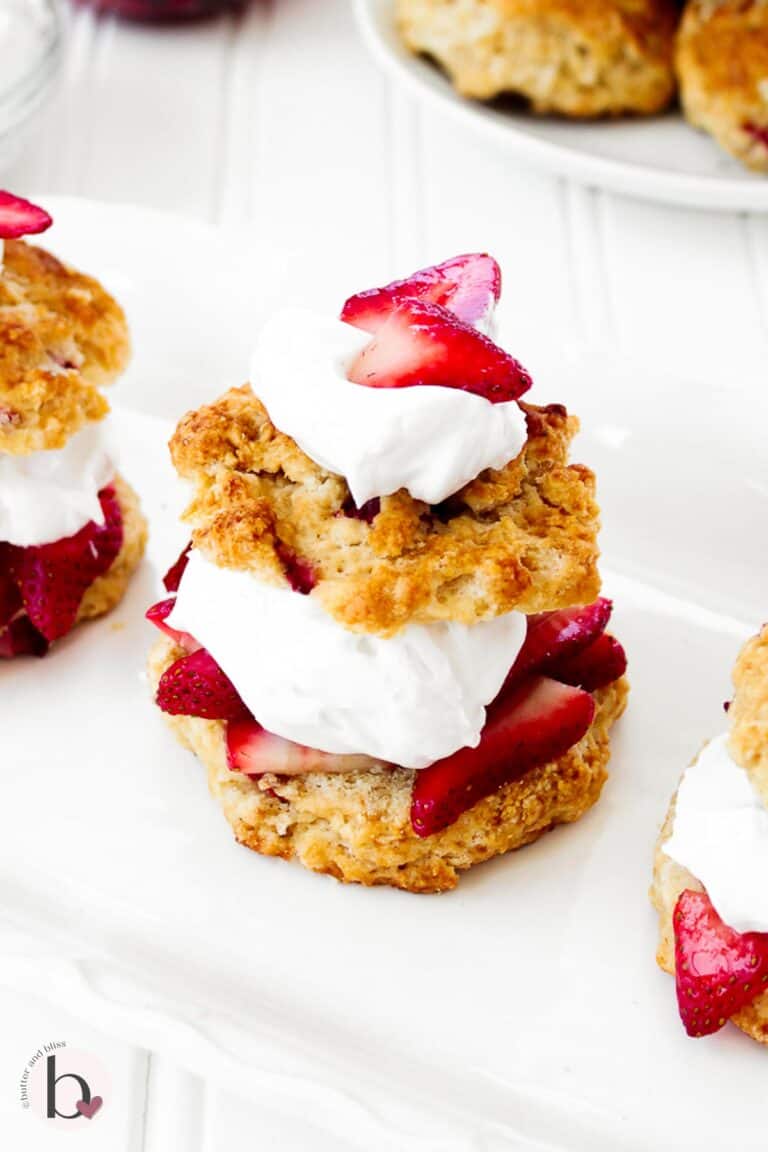 Strawberry biscuits strawberry shortcake on a white platter.