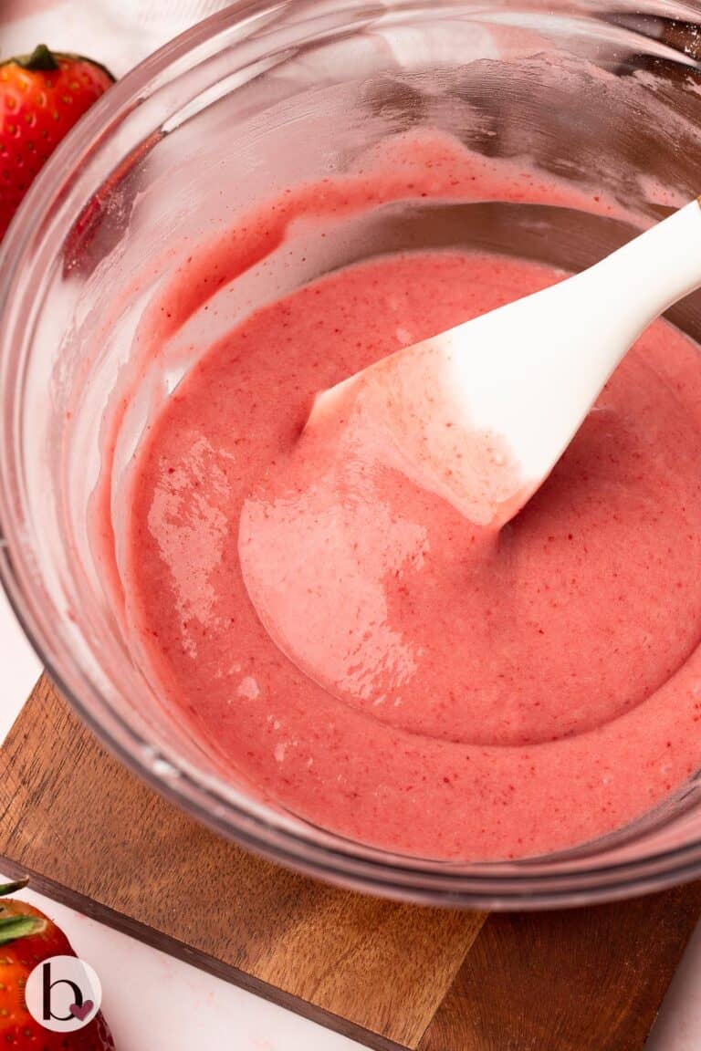 Bowl of creamy strawberry glaze in a mixing bowl.