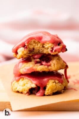 Stack of strawberry biscuit cookies with drippy strawberry glaze.
