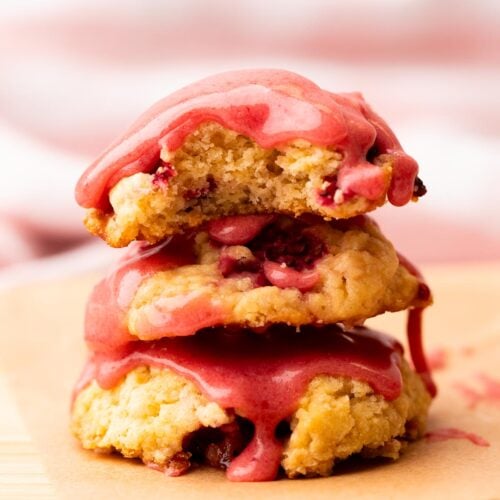 Stack of strawberry biscuit cookies with drippy strawberry glaze.