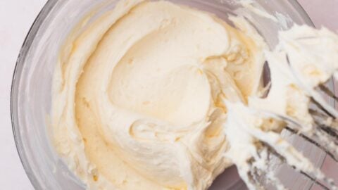 Fluffy vanilla buttercream frosting in a mixing bowl.