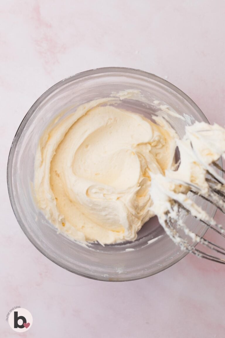Fluffy vanilla buttercream frosting in a mixing bowl.