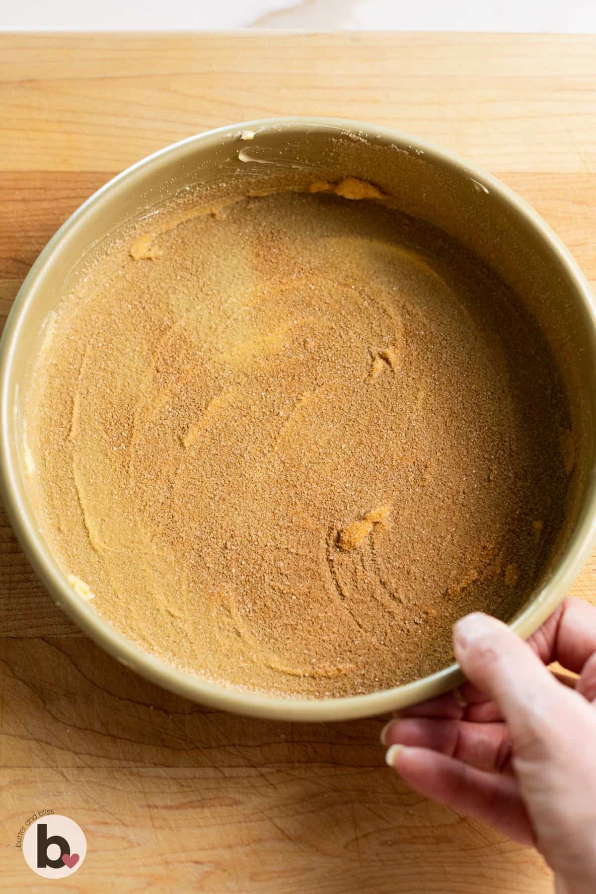 Greased cake pan sprinkled with cinnamon sugar.