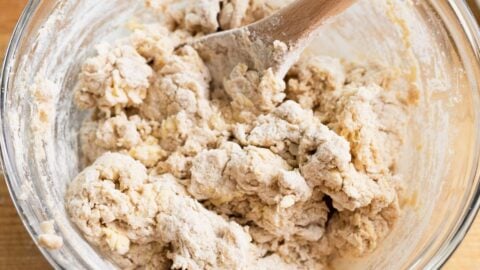 Biscuit dough being mixed in a bowl.