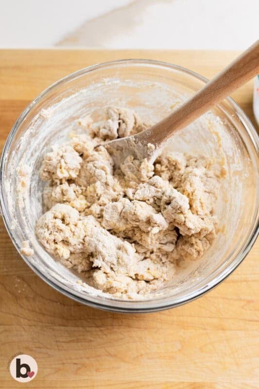 Biscuit dough being mixed in a bowl.