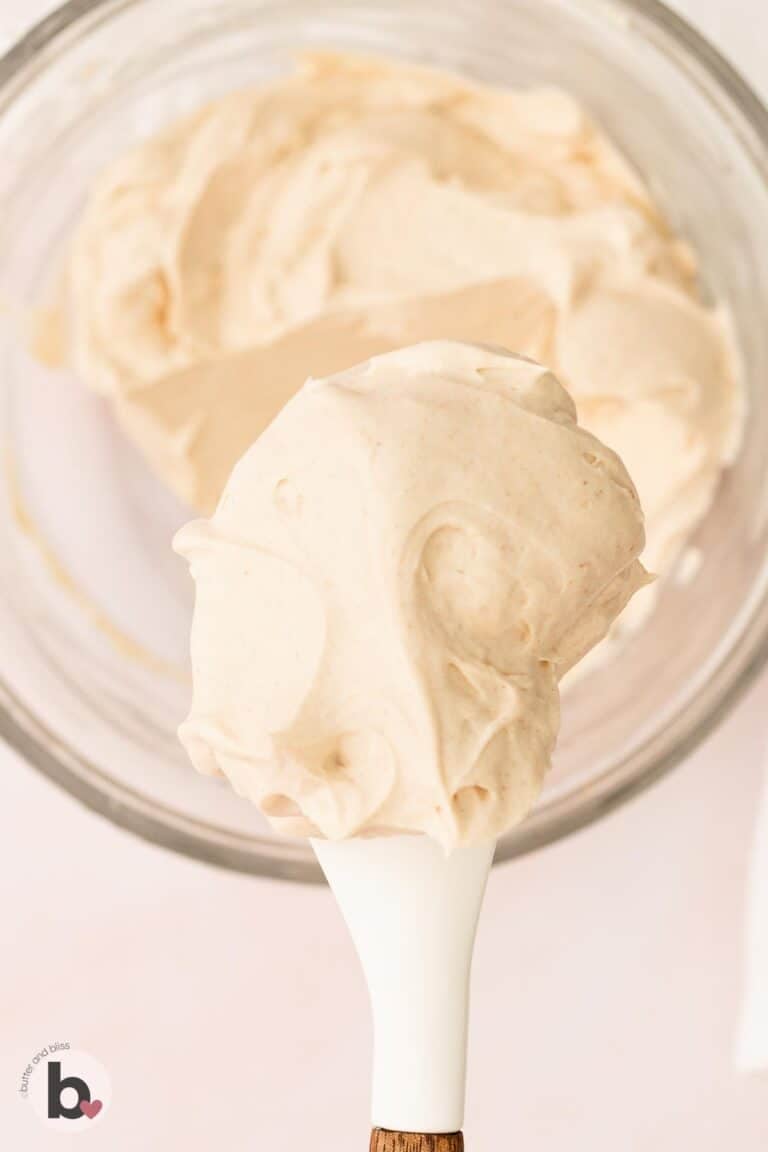 Creamy cinnamon maple cream cheese frosting on a spatula.