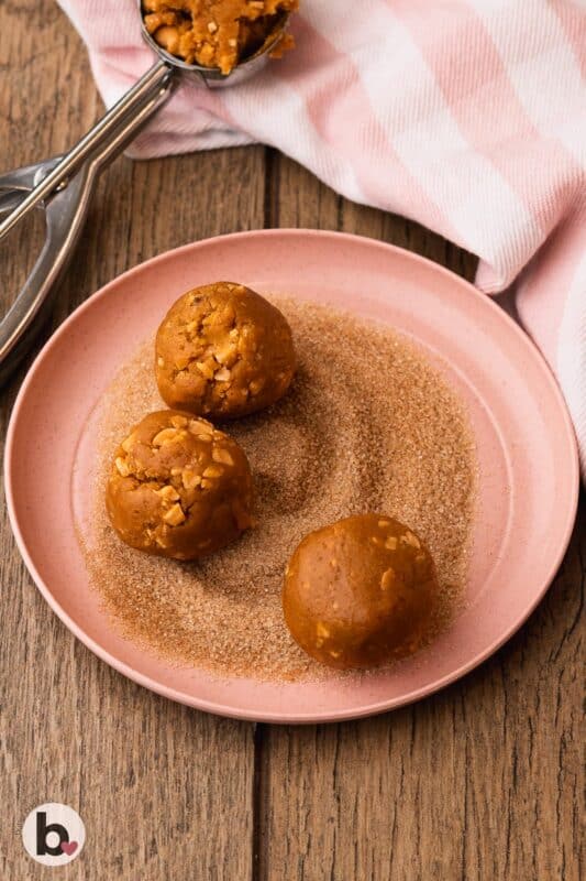 Pumpkin cookies rolled through cinnamon sugar.