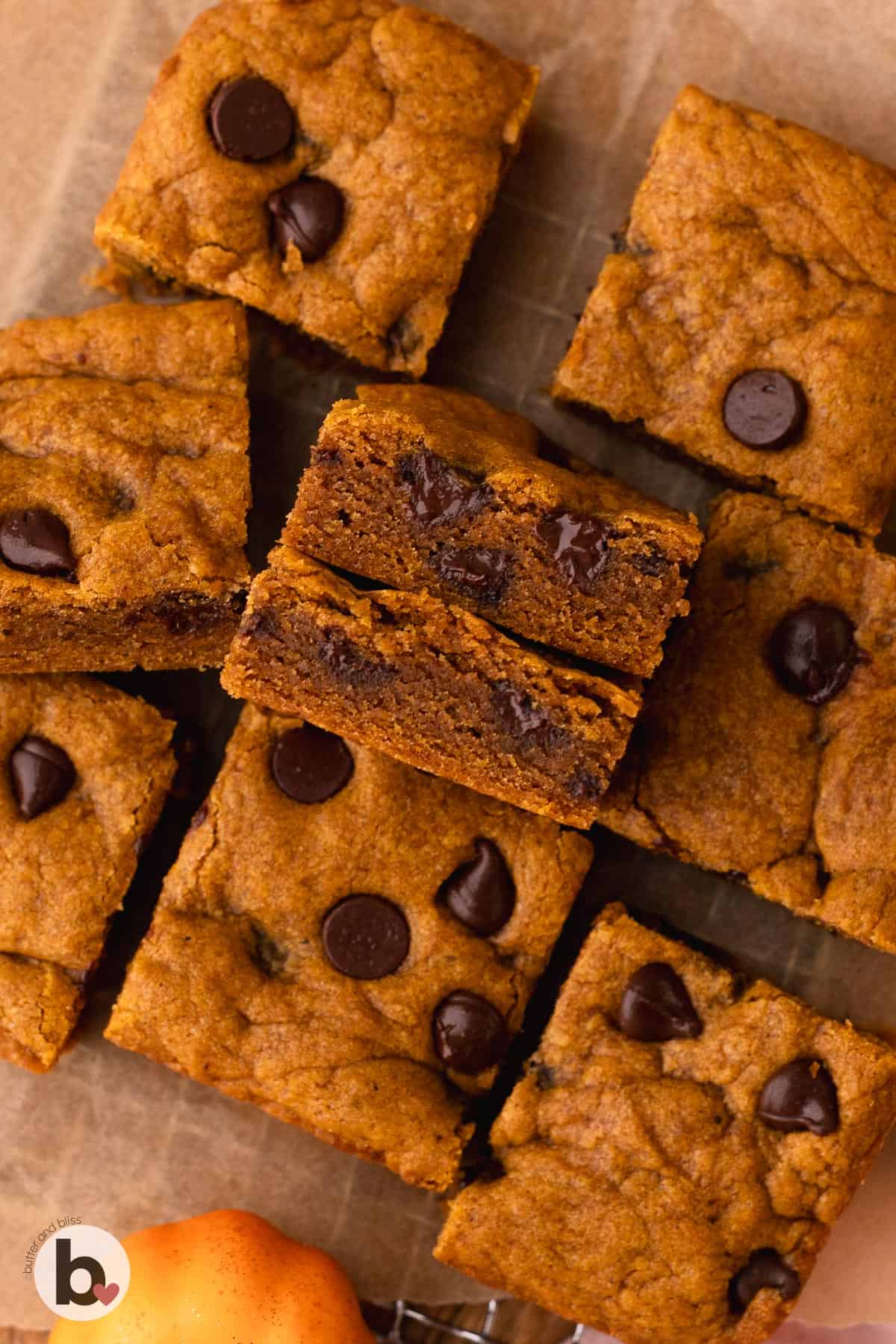 Pumpkin cookie bar squares revealing the gooey inside.