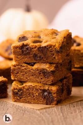 A stack of three thick and chewy chocolate chip pumpkin bars.