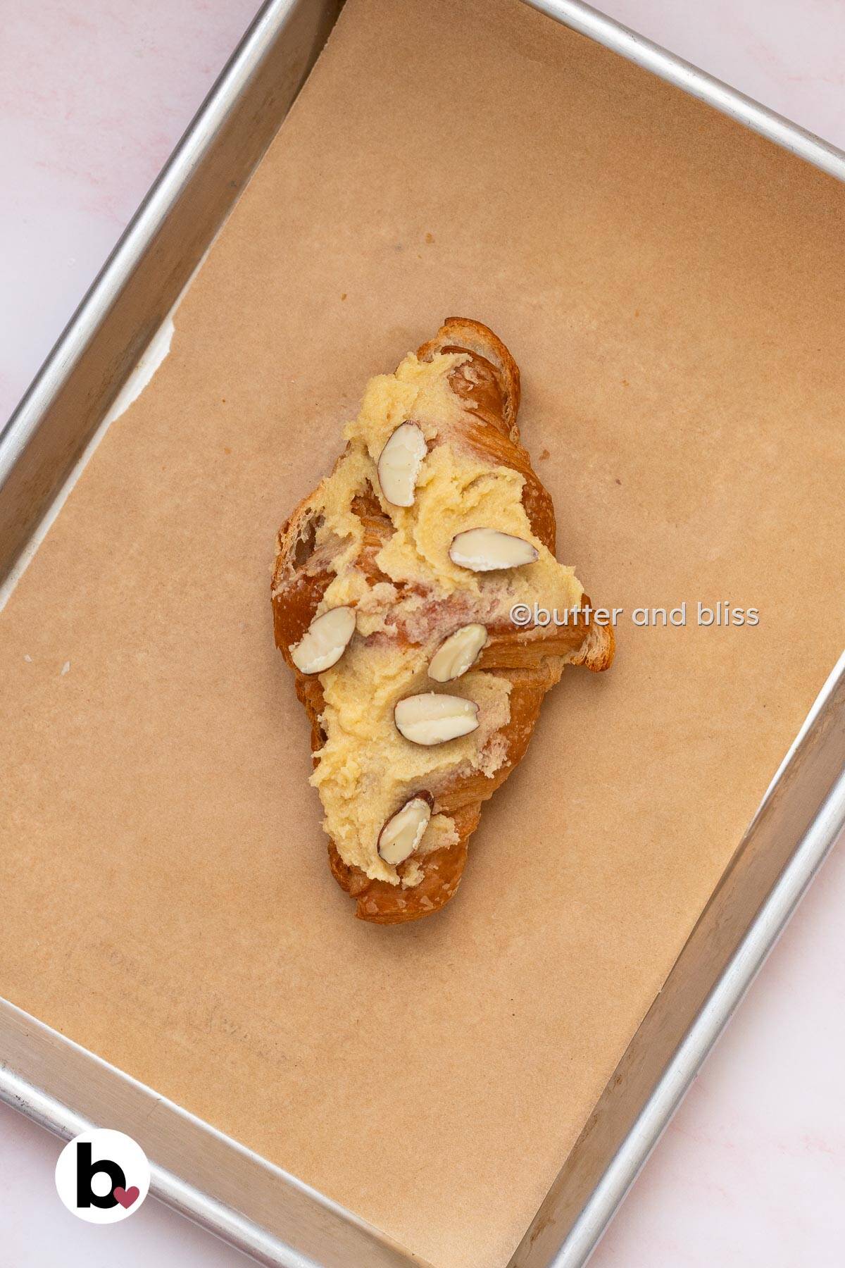 Butter and Bliss almond cream spread on the top of a croissant with almond slivers.