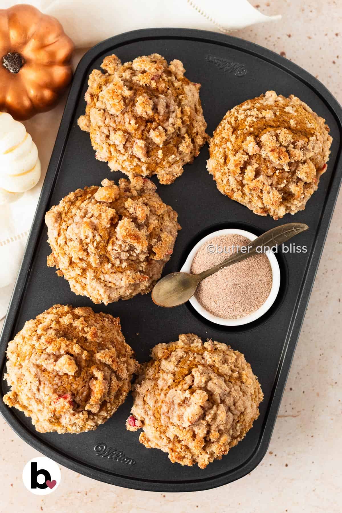 Butter and Bliss small batch apple streusel pumpkin muffins in a muffin pan.