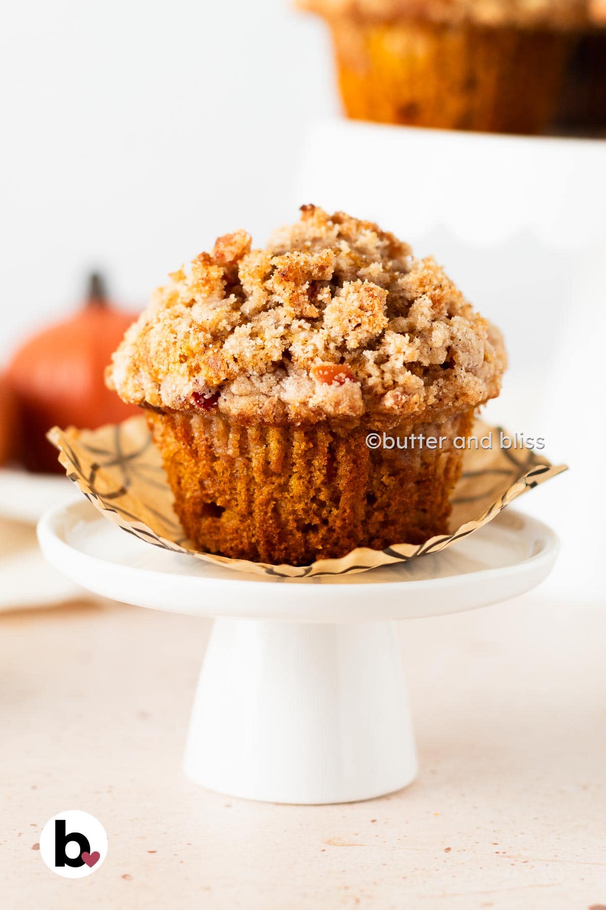 Butter and Bliss apple pumpkin streusel muffin on mini cupcake stand.