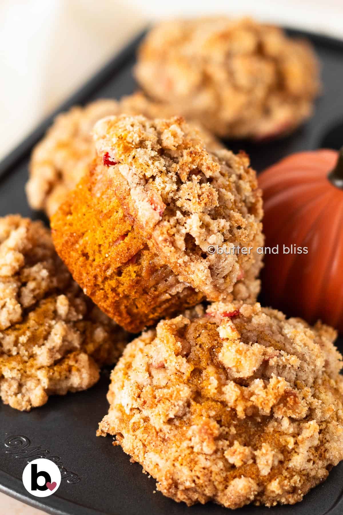 Butter and Bliss small batch apple pumpkin streusel muffins in a muffin tin.