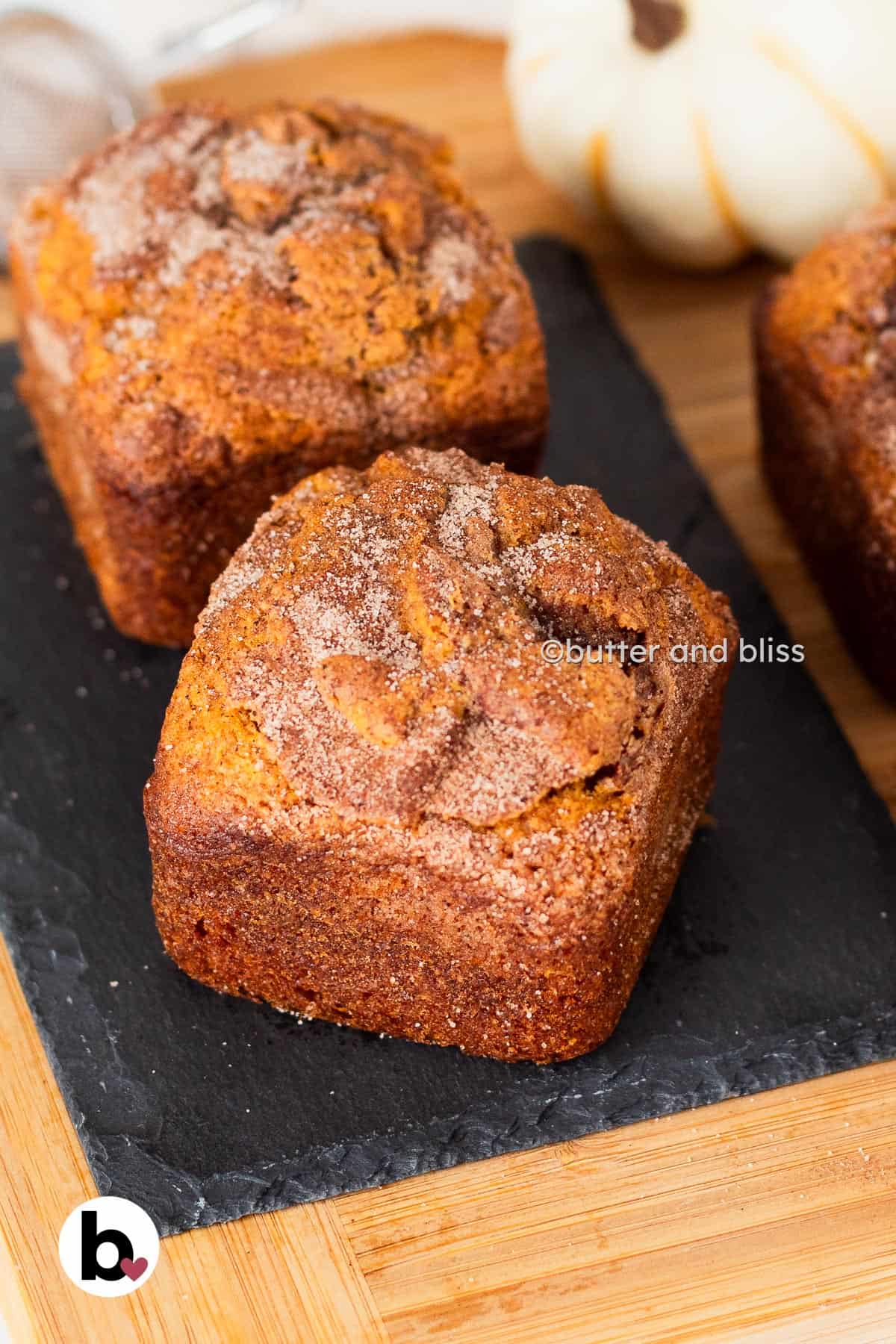 Butter and Bliss small batch pumpkin bread mini loaves on a wood platter.