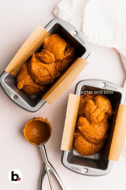 Butter and Bliss pumpkin bread batter scooped into mini loaf pans.
