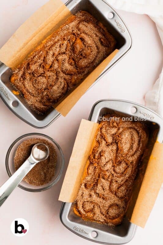 Cinnamon sugar swirled on top of pumpkin bread batter in mini loaf pans.