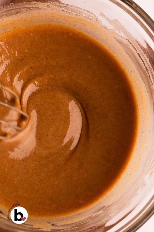 Creamy brown butter cinnamon glaze in a mixing bowl.