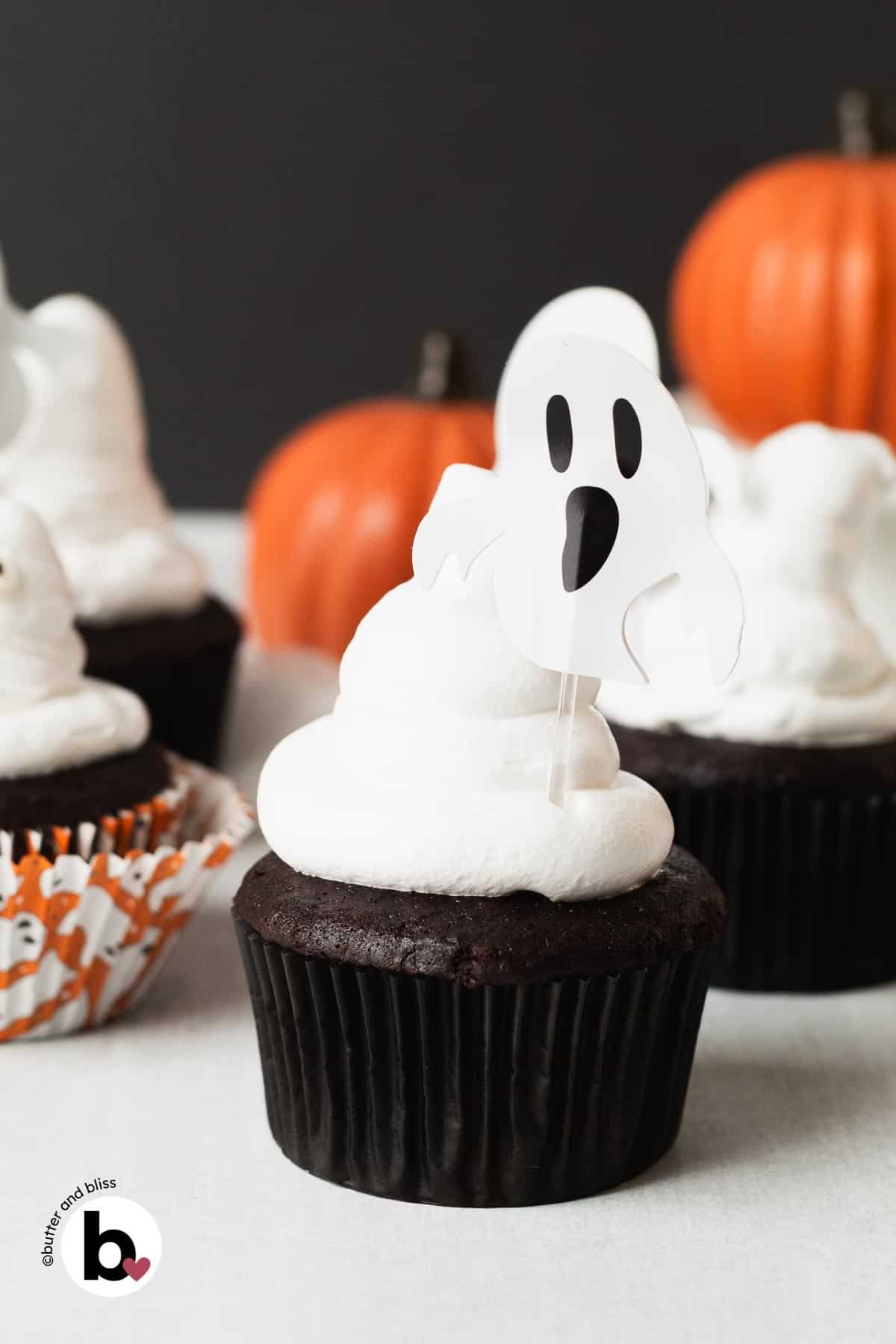 Small batch Halloween chocolate cupcakes decorated with marshmallow ghosts on a table.