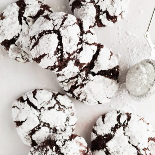 Small batch of fudgy chocolate crinkles arranged on a table.