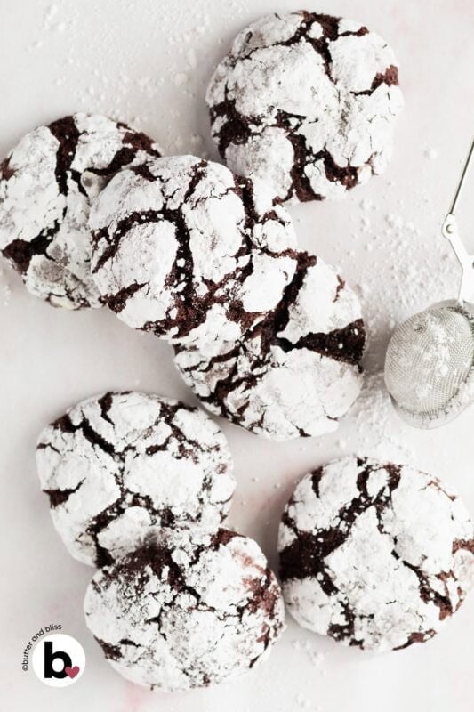 Small batch of fudgy chocolate crinkles arranged on a table.