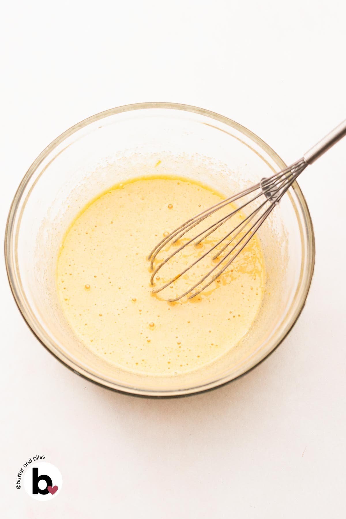 Eggs and sugar whisked until frothy in a mixing bowl.