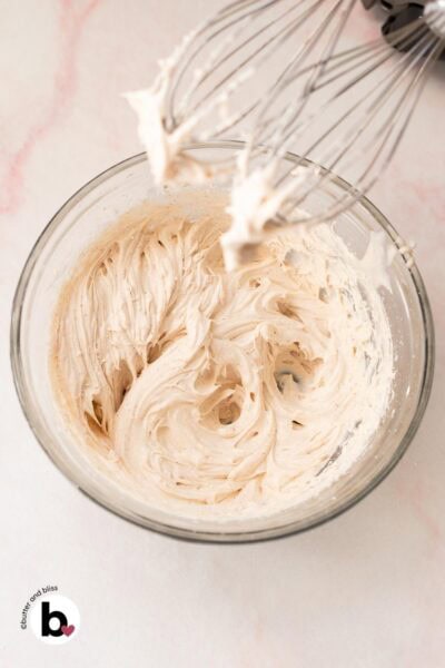 Fluffy maple cream cheese frosting in a mixing bowl.