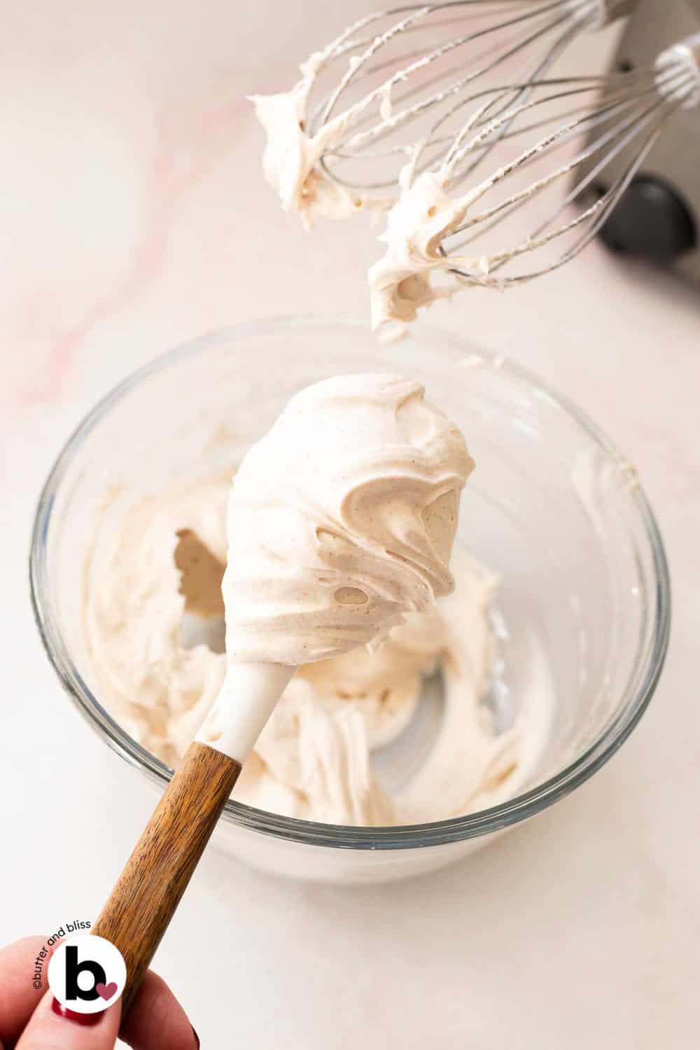 Fluffy maple cinnamon cream cheese frosting on a spatula.