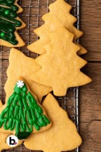 Small batch sugar cookie tree cutouts ready to be decorated on a wire rack.