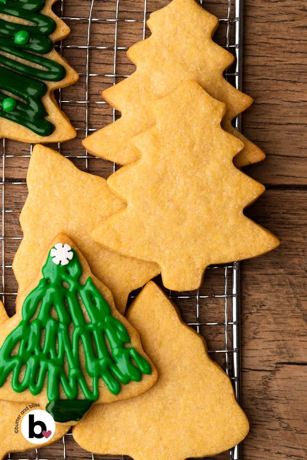 Small batch sugar cookie tree cutouts ready to be decorated on a wire rack.