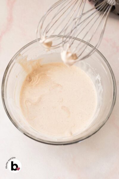 Heavy cream added to mixing bowl of whipped cream cheese.