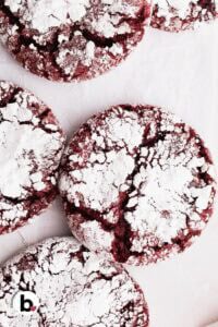 Pretty red velvet crinkle cookies close up, with powdered sugar crevices.