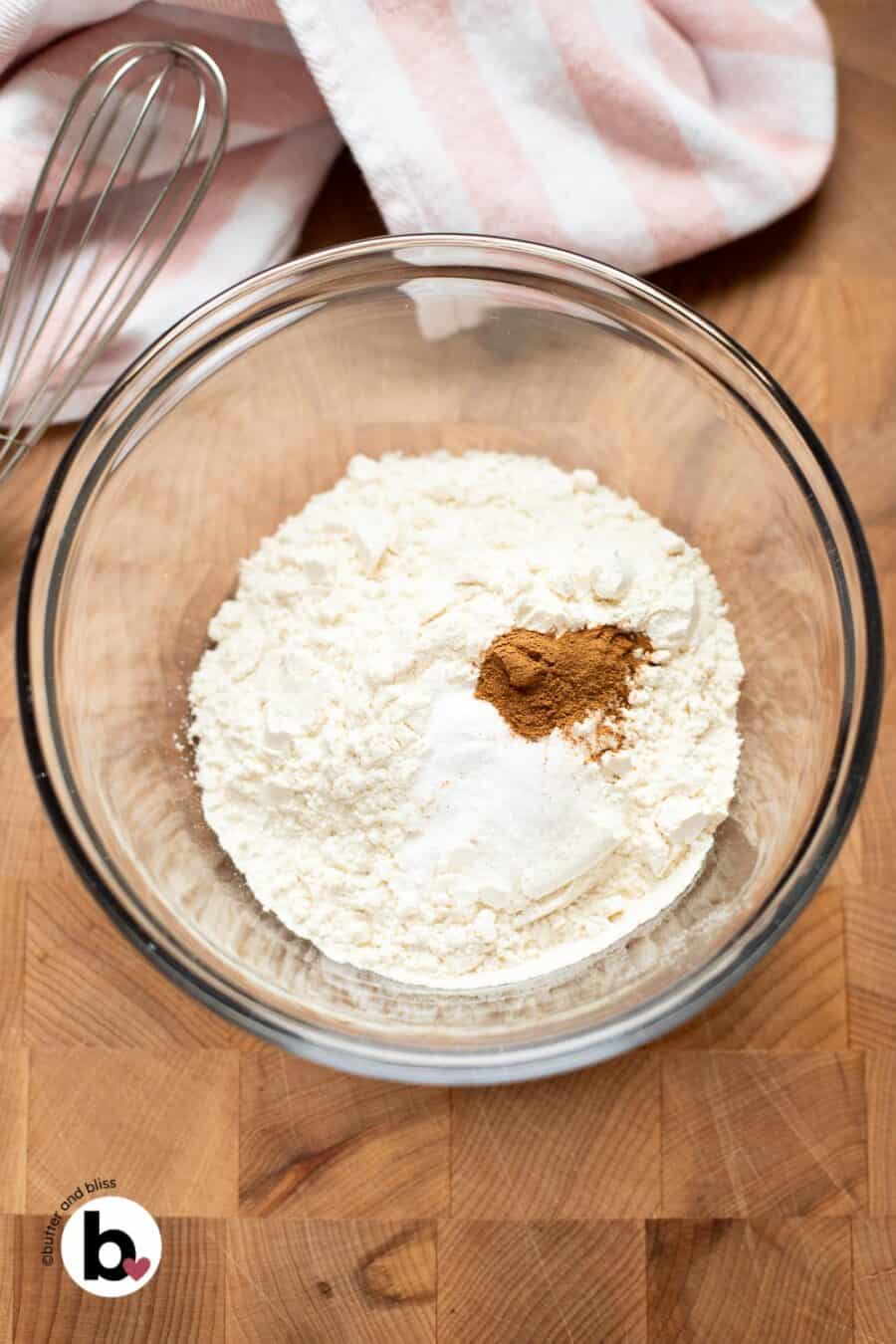 Dry cookie ingredients in a mixing bowl, ready to be whisked together.