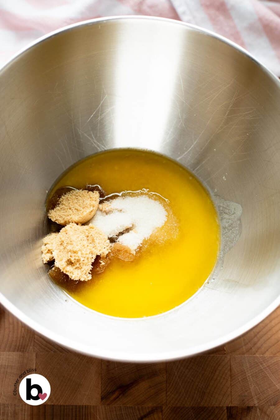 Sugar and melted butter ready to be mixed in a mixing bowl.
