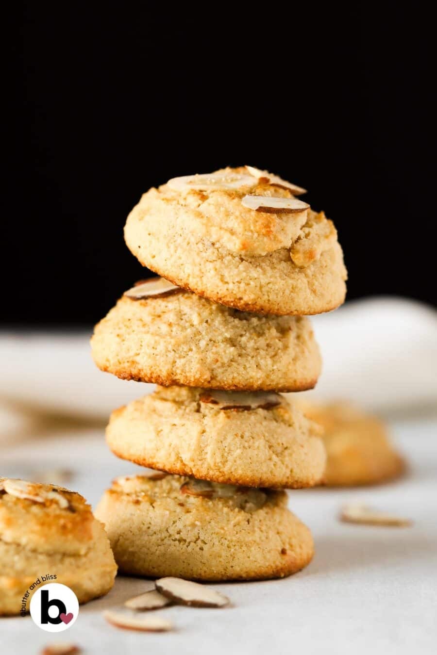 A stack of four soft-baked almond flour cookies on a table.