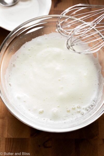 Frothy egg whites in a mixing bowl.