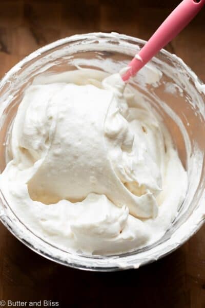 Pillowy angel food cake batter being mixed in a bowl.