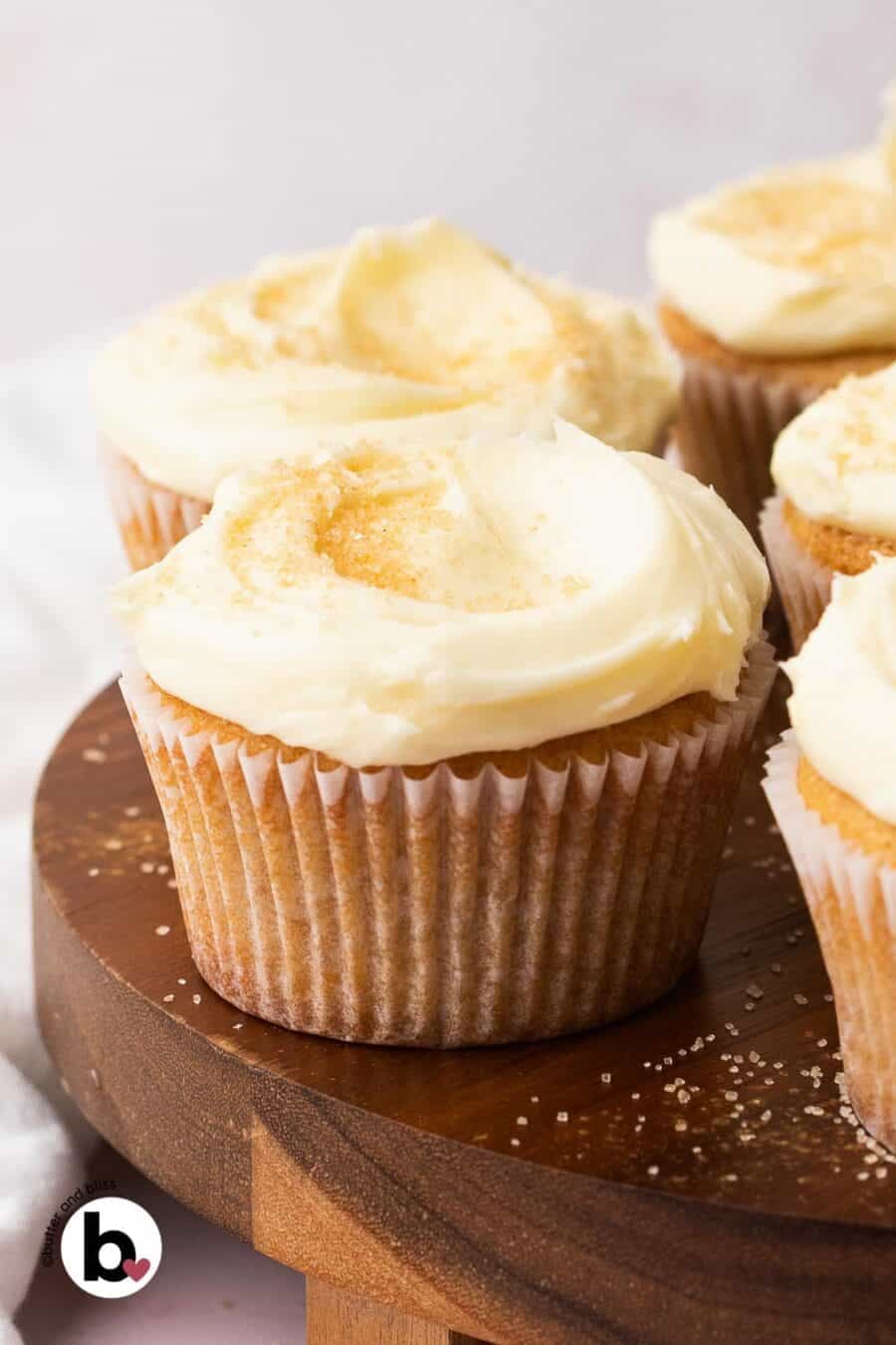 Plate of cupcakes covered with cream cheese buttercream frosting.