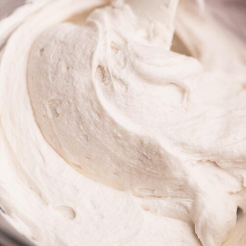 Thick and creamy vanilla frosting made without butter or cream cheese in a mixing bowl.