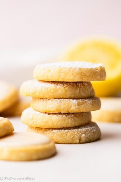 Stack of butter lemon shortbread cookies on a table.