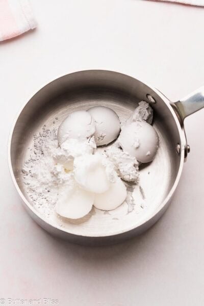 Coconut cream and coconut oil in a small saucepan to make frosting.