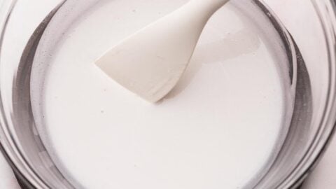Melted coconut cream and oil in a mixing bowl to make frosting.